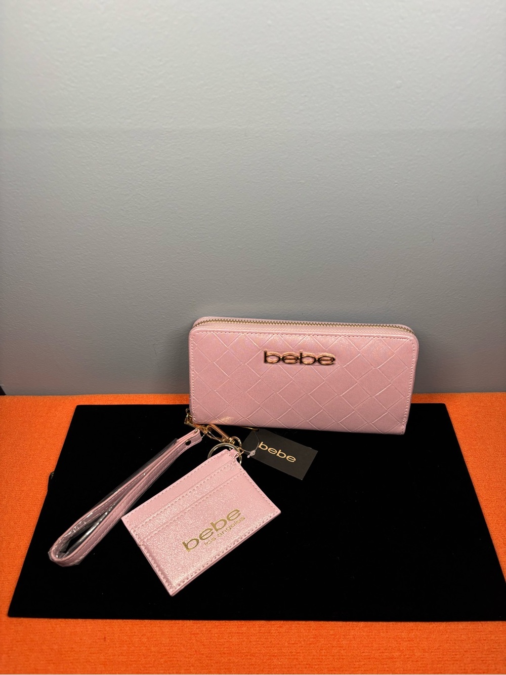 bebe Jenna Embossed Wallet Wristlet in Pink with Gold Logo